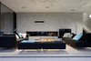 Modern home with Living Room, Ceiling Lighting, Coffee Tables, Concrete Floor, Wood Burning Fireplace, Standard Layout Fireplace, Sofa, Bench, Console Tables, and Recessed Lighting. The living room. Photo 4 of La Mira Ra