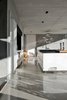 Modern home with Kitchen, Range, Concrete Counter, Ceiling Lighting, Refrigerator, Wall Oven, Concrete Floor, White Cabinet, Cooktops, and Pedestal Sink. The kitchen. Photo 8 of La Mira Ra