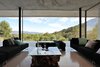 Modern home with Living Room, Bench, Ceiling Lighting, Sofa, Concrete Floor, Chair, and Coffee Tables. The living room. Photo 18 of La Mira Ra