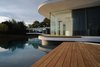 Modern home with Outdoor, Back Yard, Large Patio, Porch, Deck, Trees, Infinity Pools, Tubs, Shower, Concrete Pools, Tubs, Shower, Large Pools, Tubs, Shower, and Wood Patio, Porch, Deck. The deck Photo 5 of White Snake house