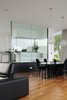 Modern home with Dining Room, Lamps, Medium Hardwood Floor, Chair, Table, Ceiling Lighting, Recessed Lighting, and Pendant Lighting. The dining room next to the kitchen Photo 10 of White Snake house