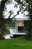 Modern home with Exterior, House Building Type, Flat RoofLine, Green Roof Material, Concrete Siding Material, and Glass Siding Material. The house ontop of the lake Photo 14 of White Snake house
