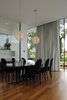 Modern home with Dining Room, Table, Medium Hardwood Floor, Chair, Lamps, Ceiling Lighting, Recessed Lighting, and Pendant Lighting. The dining room Photo 11 of White Snake house