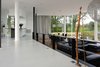 Modern home with Living Room, Concrete Floor, Sofa, Ceiling Lighting, Lamps, Recessed Lighting, and Pendant Lighting. The Living room and the kitchen Photo 9 of White Snake house