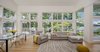 Modern home with Living Room, Medium Hardwood Floor, Pendant Lighting, Chair, Sectional, End Tables, and Track Lighting. View of dining room and living room Photo 11 of Khabensky Residence