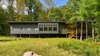 Modern home with Exterior, Metal Roof Material, Shed RoofLine, House Building Type, and Wood Siding Material. View from Lake Photo 3 of Dickerman Residence