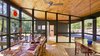 Modern home with Exterior, Wood Siding Material, House Building Type, Metal Roof Material, and Shed RoofLine. View of screen porch and entry Photo 12 of Dickerman Residence