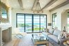 Modern home with Living Room, Chair, Sofa, End Tables, Console Tables, Ceiling Lighting, Table Lighting, Coffee Tables, Accent Lighting, Light Hardwood Floor, Standard Layout Fireplace, and Gas Burning Fireplace. 155 Bannerman Beach Lane :: Living Space Photo 6 of 155 Bannerman Beach Lane