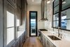 Modern home with Kitchen, Marble Counter, Pendant Lighting, Recessed Lighting, Wood Cabinet, Medium Hardwood Floor, Marble Backsplashe, Refrigerator, Range, Range Hood, and Undermount Sink. 155 Bannerman Beach Lane :: Butler's Pantry Photo 14 of 155 Bannerman Beach Lane