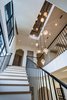 Modern home with Staircase, Wood Tread, and Metal Railing. 155 Bannerman Beach Lane :: Stairwell + Elevator Photo 18 of 155 Bannerman Beach Lane