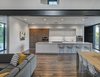 Modern home with Kitchen, Quartzite Counter, White Cabinet, Wood Cabinet, Recessed Lighting, Refrigerator, Wall Oven, Dark Hardwood Floor, Ceramic Tile Backsplashe, Cooktops, Wine Cooler, Dishwasher, Microwave, and Undermount Sink. View of the kitchen. (2017) Photo 5 of 530 house