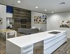 Modern home with Living Room, Chair, Sectional, Bench, Bookcase, Coffee Tables, Gas Burning Fireplace, Ribbon Fireplace, Recessed Lighting, and Dark Hardwood Floor. View of the dining and living room areas from the kitchen island. (2017) Photo 7 of 530 house