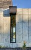 Modern home with Exterior, House Building Type, and Concrete Siding Material. View showing a rain chain downspout at the north. The entire roof utilizes rain chains. The window beyond. (2017) Photo 12 of 530 house