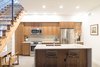 Modern home with Kitchen, Granite Counter, Wood Cabinet, Concrete Floor, Porcelain Tile Backsplashe, Recessed Lighting, and Undermount Sink. Kitchen with glulam stair Photo of Menlo Park Residence