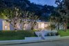 Modern home with Outdoor, Front Yard, Trees, Shrubs, Grass, Hardscapes, Gardens, Flowers, Raised Planters, and Walkways. Front at night Photo 2 of Benton Park, AIA Mid Century Modern