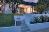 Modern home with Outdoor, Front Yard, Garden, Slope, Trees, Shrubs, Grass, Hardscapes, and Gardens. Front at night Photo 3 of Benton Park, AIA Mid Century Modern