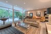 Modern home with Living Room, Sofa, Bench, Chair, Ottomans, End Tables, Coffee Tables, Bookcase, Ceiling Lighting, Table Lighting, Wall Lighting, Recessed Lighting, Terrazzo Floor, Two-Sided Fireplace, and Gas Burning Fireplace. Walls of glass Photo 6 of Benton Park, AIA Mid Century Modern