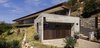 Modern home with Exterior, House Building Type, Metal Roof Material, Concrete Siding Material, and Metal Siding Material. Down-Slope Exterior Photo 3 of Crossing Wall House