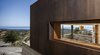 Modern home with Exterior, House Building Type, Metal Roof Material, Concrete Siding Material, and Metal Siding Material. Exterior Detail Photo 5 of Crossing Wall House