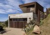 Modern home with Exterior, House Building Type, Metal Roof Material, Concrete Siding Material, and Metal Siding Material. East Exterior Photo 9 of Crossing Wall House