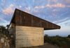 Modern home with Exterior, House Building Type, Metal Roof Material, Concrete Siding Material, and Metal Siding Material. West Exterior Photo 10 of Crossing Wall House
