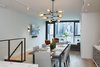 Modern home with Dining Room, Chair, Table, Storage, Ceiling Lighting, Wall Lighting, Pendant Lighting, Accent Lighting, Recessed Lighting, Light Hardwood Floor, and Hanging Fireplace. Dining Room to Living Room Photo 3 of Pierhouse At Brooklyn Bridge Park Condo
