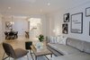 Modern home with Living Room, Ceiling Lighting, Chair, Sofa, Coffee Tables, Light Hardwood Floor, Accent Lighting, Table Lighting, Ottomans, Bench, End Tables, Medium Hardwood Floor, and Recessed Lighting. View from Living Room to Dining Room Photo 2 of Upper East Side Oasis