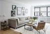 Modern home with Living Room, Chair, End Tables, Ottomans, Sectional, Coffee Tables, Recessed Lighting, Table Lighting, and Medium Hardwood Floor. Living Room Photo 7 of Upper East Side Oasis