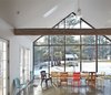 Modern home with Dining Room, Table, Chair, Recessed Lighting, Pendant Lighting, and Concrete Floor. "The hope has been to combine archaic and modern elements in a way that would enhance the beauty of each by virtue of its contrast with the other." — Tom Givone Photo 2 of The Floating Farmhouse