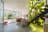 Modern home with Staircase, Wood Railing, Wood Tread, and Metal Railing. Stair with yellow-filtered light through facade Photo 6 of 4016 Tivoli
