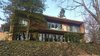 The rear of the house has a stunning 52ft of glass along the lower level and looks out onto 1.3 acres of mature Indiana hardwoods. Photo of Hendrickson Residence modern home