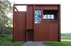 Modern home with Exterior and Wood Siding Material. Entrance to the northwest. The building is sectioned vertically similar to magazine buildings in the surrounding area. Here they have been given a function as the downpipes of the building is hidden in the pillars. The movement through the house ends with an evening sun balcony that overlooks the entrance hall Photo 6 of Späckhuggaren