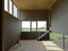 Second floor living room with its offset slab and transparency. A rolled powder coated sheet staircase leads to the building's highest placed space. The highest placed window dipped down diagonally throughout the entire building. Photo 14 of Späckhuggaren modern home