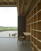 The north side of the living room with a built-in bookcase and glass opening to the wide-open landscape. Photo 12 of Späckhuggaren modern home