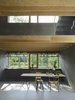 Kitchens and upper living room with slab ceilings. Light slides diagonally throughout the entire building. Photo 10 of Späckhuggaren modern home