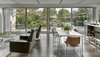 Modern home with Dining Room, Chair, Track Lighting, Table, Stools, Medium Hardwood Floor, Bar, Recessed Lighting, and Rug Floor. Living + Dining + Kitchen + Garden Photo 5 of The Gregory House