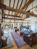 Modern home with Living Room, Ceiling Lighting, Medium Hardwood Floor, Wood Burning Fireplace, and Pendant Lighting. Interior - Existing timber frame, floor, fireplace and paneling Photo 4 of Vermont Barn to High Performance Home
