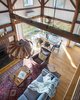 Modern home with Living Room, Chair, Table, Wood Burning Fireplace, Medium Hardwood Floor, Standard Layout Fireplace, and Ceiling Lighting. Interior - Existing timber frame, floor, fireplace and paneling Photo 5 of Vermont Barn to High Performance Home