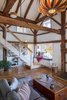 Modern home with Living Room, Ceiling Lighting, Bookcase, and Medium Hardwood Floor. Daybed at the bottom of the stairs Photo 7 of Vermont Barn to High Performance Home