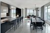 Modern home with Dining Room, Chair, Table, Ceiling Lighting, Pendant Lighting, and Concrete Floor. Social spaces are held to the perimeter to access expansive panoramic views. Photo 6 of Whiteline Residence