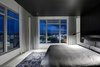 Modern home with Bed, Ceiling Lighting, Accent Lighting, Wall Lighting, Concrete Floor, Rug Floor, and Bedroom. Views to the south are reserved for the master bedroom. Photo 8 of Whiteline Residence