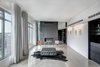 Modern home with Living Room, Gas Burning Fireplace, Concrete Floor, Wall Lighting, Bench, Chair, and Standard Layout Fireplace. The gallery contains the clients calligraphic art collection offers views to downtown. Photo 10 of Whiteline Residence