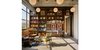 Modern home with Living Room, Chair, Ottomans, End Tables, Coffee Tables, Bookcase, Pendant Lighting, and Light Hardwood Floor. Walnut millwork room divider with adjustable shelves, stone desk and pivot door. Photo 2 of West Loop Residence