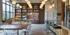 Modern home with Dining Room, Chair, Storage, Pendant Lighting, Table, Desk, Shelves, and Light Hardwood Floor. Walnut millwork room divider with adjustable shelves, stone desk and pivot door. Photo 4 of West Loop Residence