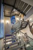 Modern home with Staircase, Glass Railing, Concrete Tread, and Metal Railing. In a modern four-story home that emphasizes views, openness and artistry the choice to design floating stairs was an obvious one. KTGY used the stairs to celebrate the transition between all 4 levels. The concrete levitating treads serve to reinforce the expansive feeling established in the home, offer a visual connection between spaces and allow light to flood the stairwell and the rooms beyond. Glass and metal handrails further push this theme of connectivity. These eye-catching stairs carry your eye upward and provide a gallery space for large pieces of art to be displayed and enjoyed. Photo 4 of Vu at MacDonald Highlands