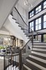 The statement staircase connects three floors of living space in the ±6,300-square-foot homes. Photo 7 of Retreat at McLean and Mehr Farm modern home