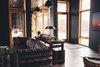 Modern home with Living Room, Sectional, Ceiling Lighting, Table Lighting, Pendant Lighting, Concrete Floor, and Wood Burning Fireplace. Living area Photo 3 of The Caudill House