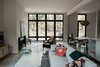 Modern home with Living Room, Pendant Lighting, Concrete Floor, Sofa, and Wood Burning Fireplace. Great room with floor-to-ceiling windows. Photo 2 of North Shore #7