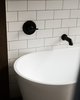 Modern home with Bath Room, Open Shower, Subway Tile Wall, Freestanding Tub, and Concrete Floor. A free standing soaking tub is located in the master bath wet room. Photo 7 of North Shore #7