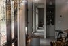 Modern home with Living Room, Concrete Floor, and Wood Burning Fireplace. View into the great room and hallway from the exterior window Photo 10 of North Shore #7